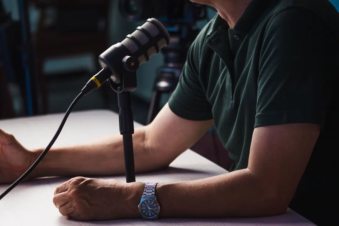 Example YouTube thumbnail with a podcast host at a microphone